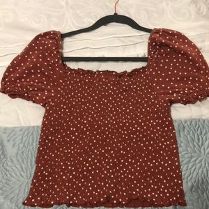 Short pinkish shirt with white polka dots